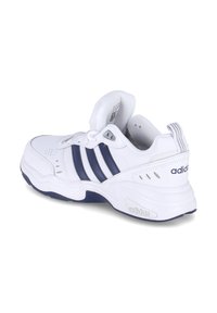 White athletic sneaker with navy blue stripes, synthetic upper, padded collar, textured rubber sole, and printed branding on the heel.