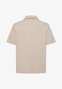 Short-sleeve shirt in light beige fabric, featuring a classic collar and straight cut. Back view shows two shoulder seams and a smooth texture.