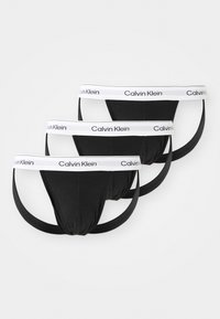 Bañadores de algodón negros con una cinturilla elástica blanca que presenta el logo "Calvin Klein", diseñados en un estilo ajustado con costuras mínimas.