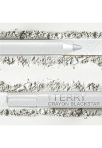 Crayon blanc avec une finition métallisée, surface texturée et coque transparente, posé sur un fond de poudre blanche écrasée.