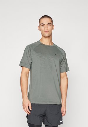 Gray athletic t-shirt with short sleeves, round neckline, and subtle texture. Features a black Nike logo on the left chest area.