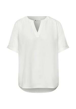 Blouse blanche à manches courtes avec un col en V, de légers fronces aux épaules et un ourlet arrondi.