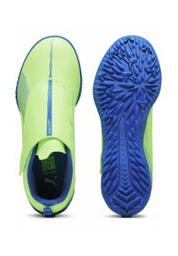 Green athletic shoes with a smooth upper, blue accents, and a textured outsole designed for grip. Features a slip-on design with a tab.