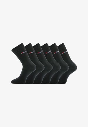 Six chaussettes de travail noires avec le logo FILA en blanc et rouge sur le bord, disposées côte à côte sur un fond blanc.