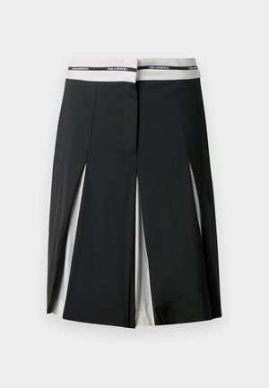 Μαύρη midi φούστα με λευκές πλευρικές λωρίδες και λεπτομέρειες με σχισμές, διαθέτοντας λευκή ζώνη μέσης με το λογότυπο "KARL LAGERFELD" σε μαύρο χρώμα.