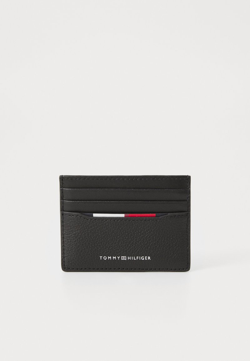 Black leather cardholder featuring multiple card slots, a textured finish, and embossed branding on the front. Compact and sleek design.
