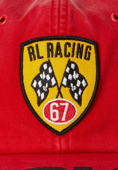 Casquette de base-ball rouge avec un patch représentant un blason jaune affichant "RL RACING", deux drapeaux à damiers, et le numéro "67" en blanc sur un ovale rouge.