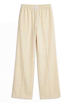 Pantaloni color crema con sottili righe verticali bianche e vita elastica, mostrati distesi su sfondo bianco.