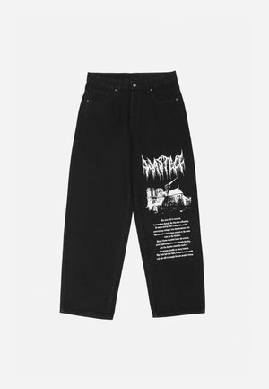 Zwarte wijde jeans met een witte afbeelding van een kathedraal en blokletters op de rechterdij.