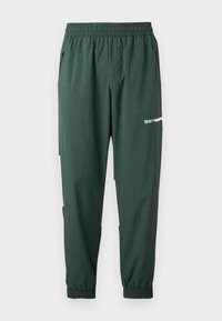 Σκουροπράσινο στενό παντελόνι φόρμας με ελαστική μέση και μανσέτες, λεπτό μοτίβο σε πλέγμα, τσέπες με φερμουάρ στο πλάι και λευκό λογότυπο "ea7" στο μηρό.