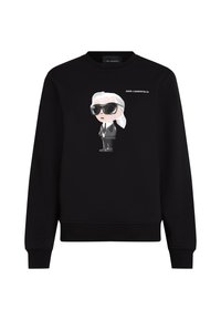 Hanorac negru cu o ilustrație de desen animat a unei figuri cu ochelari de soare și costum, cu inscripția „KARL LAGERFELD” deasupra.