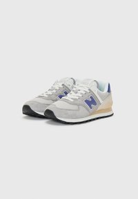 Gray sneaker with mesh and suede materials, featuring a blue logo, white laces, and a black sole. Light blue accents at the heel.