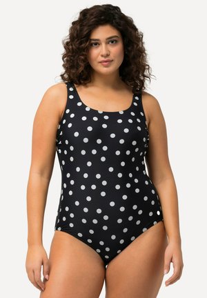 Costume intero nero con pois bianchi, dotato di spalline larghe e scollo a barca. Realizzato in un materiale morbido e elasticizzato.