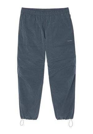 Tmavosivé elastické nohavice s bočnými vreckami na zips a nastaviteľnými sťahovacími šnúrami pri elastických členkoch, s jemným logom Calvin Klein.