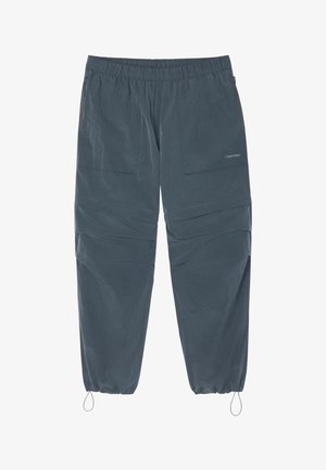 Tumedat hallid elastse vöökohaga püksid lukuga küljetaskute ja reguleeritavate paeltega elastsete säärte juures, millel on peen Calvin Kleini logo.