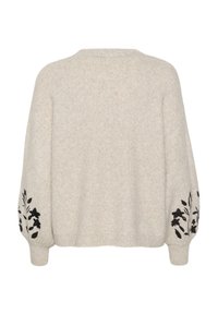 Pull en maille beige clair avec épaules tombantes et manches longues. Broderie florale noire sur les manches. Texture douce, coupe décontractée.