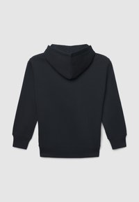 Felpa nera con maniche lunghe e polsini e orlo a costine, mostrata da dietro su uno sfondo grigio chiaro uniforme.