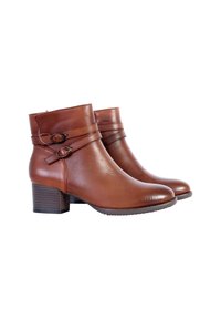 Brown leather ankle boots with a rounded toe, block heel, and dual straps featuring circular accents. Smooth texture with a polished finish.