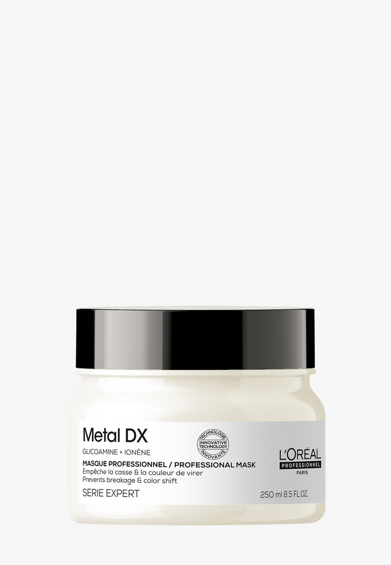 Barattolo di maschera per capelli L'Oréal Professionnel Metal DX con coperchio nero, etichetta bianca, previene la rottura e lo spostamento del colore, formato 250 ml.