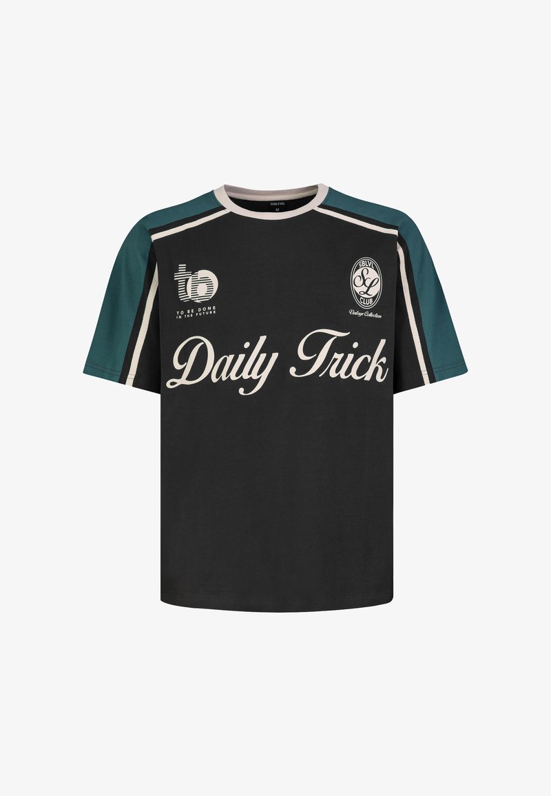 Black and green short-sleeve t-shirt with white trim, featuring "Daily Trick" text and logos on chest.