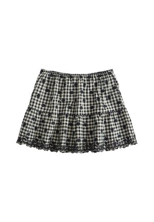 Zwart-witte geruite rok met kleine zwarte bloemenprints en kanten rand langs de onderkant, elastische tailleband en geplooide stof.