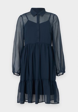 Rochie transparentă bleumarin cu nasturi în față, guler și mâneci lungi. Are o fustă stratificată și cusături delicate pe la manșete.