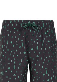 Costumi da bagno neri con motivo di cactus verdi e onde, cintura elasticizzata con cordino e dettaglio della tasca laterale.