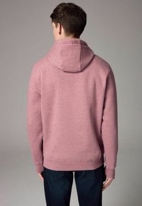 Sudadera con capucha de mezcla de algodón en rosa claro, que presenta un corte relajado, puños y dobladillo acanalados, con una gran capucha trasera y una textura suave.