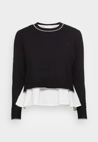 Black knit sweater with a white peplum layer, silver trim at the neckline and hem, long sleeves, and ribbed cuffs. Soft texture.