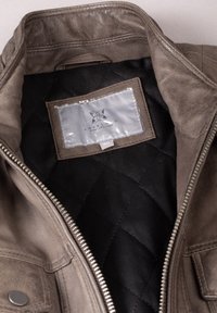 Brown leather jacket featuring a quilted black lining, silver zipper, and a label reading "LAKELAND FINE LEATHER" on the inside. Size 40.