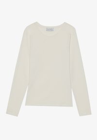 Long-sleeve t-shirt in light beige cotton with a crew neck, featuring minimal stitching and a relaxed fit. Tag visible at the neckline.