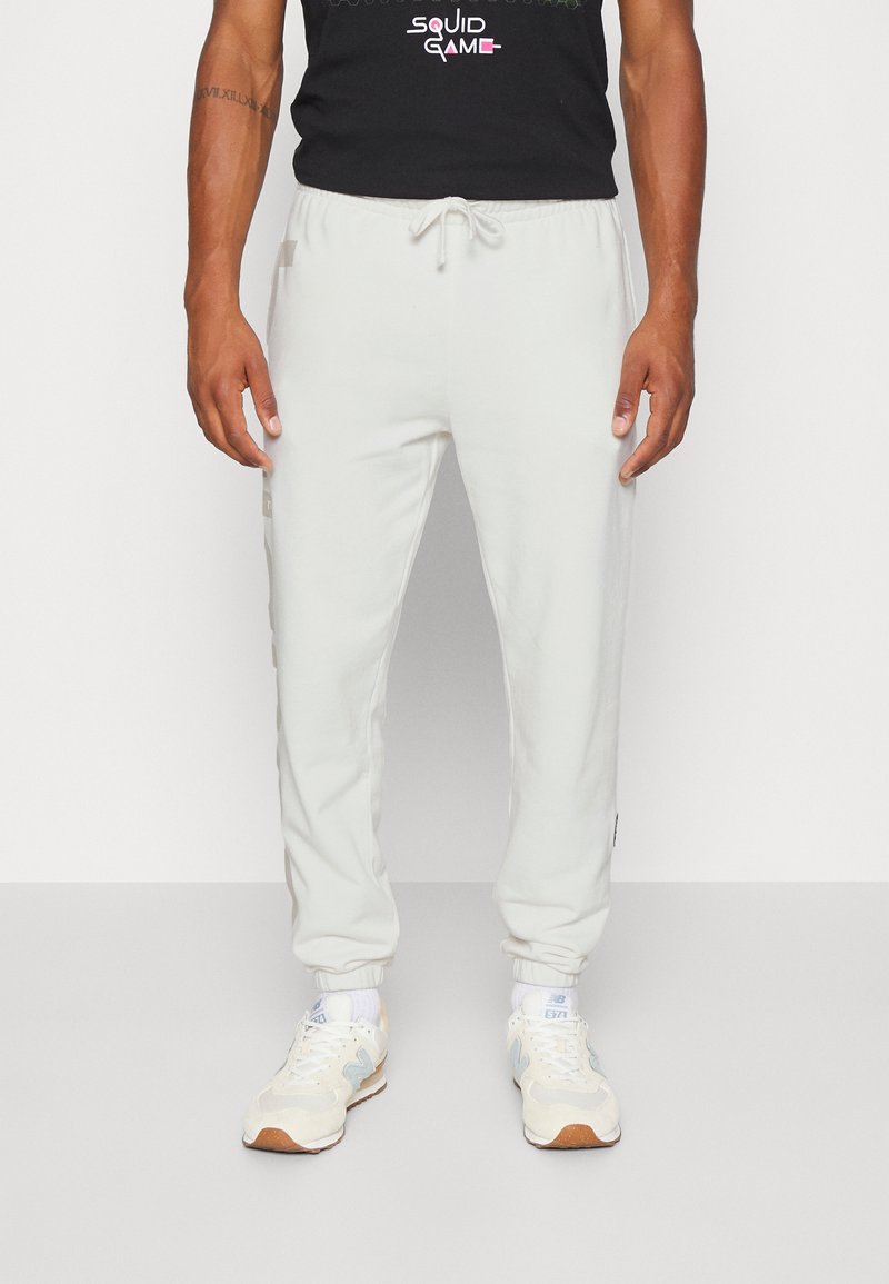 New Balance ATHLETICS OUT OF BOUNDS PANT UNISEX Tracksuit bottoms sea salt/sand Zalando.ie