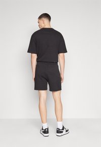 Tommy Jeans BADGE CARGO  - Tracksuit bottoms - black