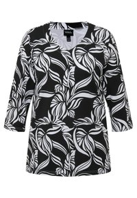 Černobílé tričko s výstřihem do V, s celoplošným vzorem listů. Vyrobeno z hladké látky, s rukávy po tři čtvrtiny a uvolněným střihem.