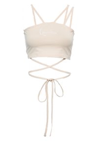 Beige cropped top met verstelbare spaghetti bandjes. Heeft een kruislings ontwerp en een strikdetail aan de voorkant. Zachte stof met geborduurd logo.