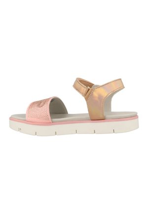 Pink and gold sandals with a textured strap, adjustable ankle closure, and a white cushioned sole. Flat design suitable for casual wear.
