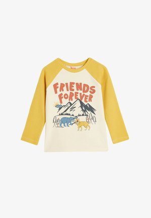 Camicia a maniche lunghe in cotone con maniche raglan gialle, corpo color crema con il testo "AMICI PER SEMPRE" e un'immagine di animali contro le montagne.