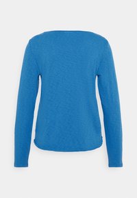 Modrá košile s dlouhým rukávem z texturované látky, se rovým střihem a zaobleným výstřihem, s mírně zakřiveným spodním lemem vzadu.