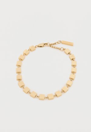 Gold-tone bracelet featuring geometric square links with a smooth texture, attached by metal chain, and a clasp with logo tag.