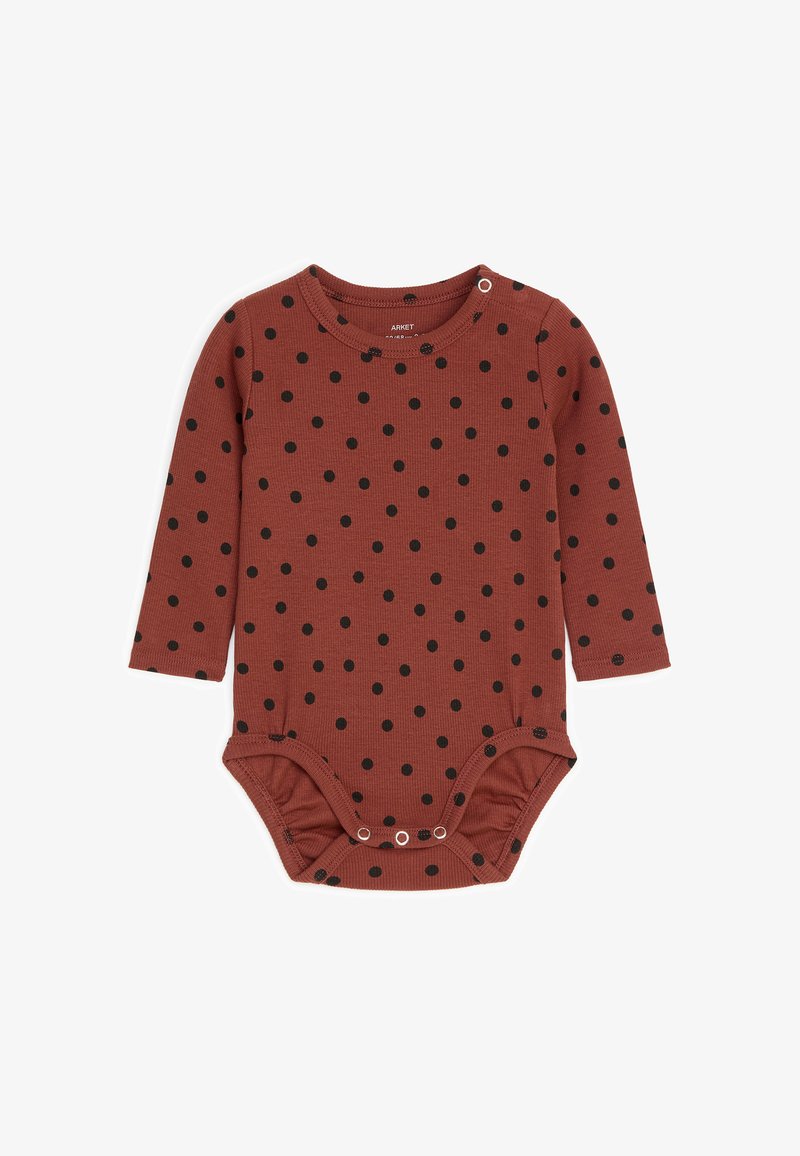 Body bébé à manches longues couleur rouille avec pois noirs, boutons-pression à l'épaule et à l'entrejambe pour un habillage facile.