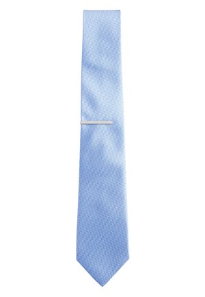 Light blue textured necktie with a silver tie bar clipped horizontally near the wider end on a white background.