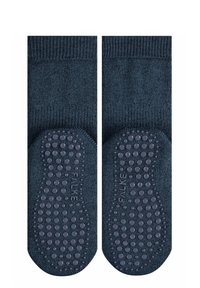 Granatowe skarpetki z fakturowanym wierzchem i gumowanymi punktami na podeszwach. Gładka tkanina z prążkowanym wykończeniem w okolicy kostki.
