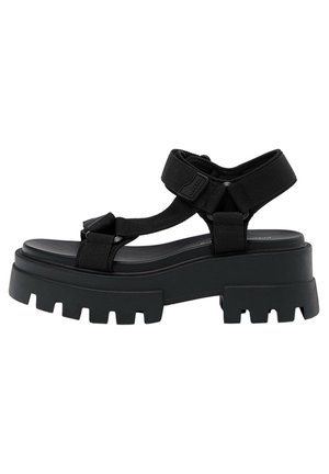 Sorte chunky platformsandaler med brede remme, justerbare spænder og en tekstureret sål med dybe riller for bedre greb.