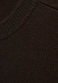 Dark brown knit sweater fabric showing ribbed texture and a round neckline. The surface features a consistent, tightly woven pattern.