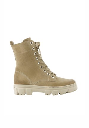 Beige suede lace-up combat boot with thick treaded rubber sole and ankle-high shaft.