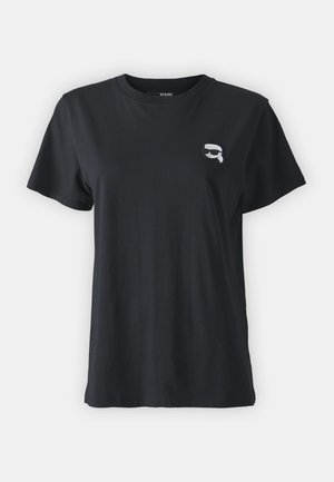 Black cotton T-shirt with short sleeves and a round neckline. Features a small, white graphic on the chest. Smooth texture, casual fit.