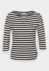 Svart och vit randig långärmad skjorta med rundad halsringning och en liten 'ck'-logotyp på bröstet, tillverkad av mjukt tyg.