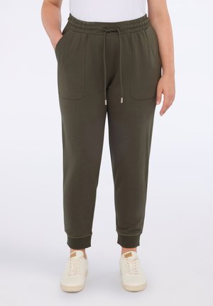 Olivgrüne Jogginghosen aus weichem Stoff, mit elastischem Bund, Kordelzug, zwei Vordertaschen und schmal zulaufenden Bündchen.