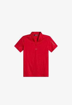 Czerwona koszulka polo z krótkim rękawem i kołnierzykiem, z złotym logo na środku oraz nazwą marki na rękawie. Gładka faktura.