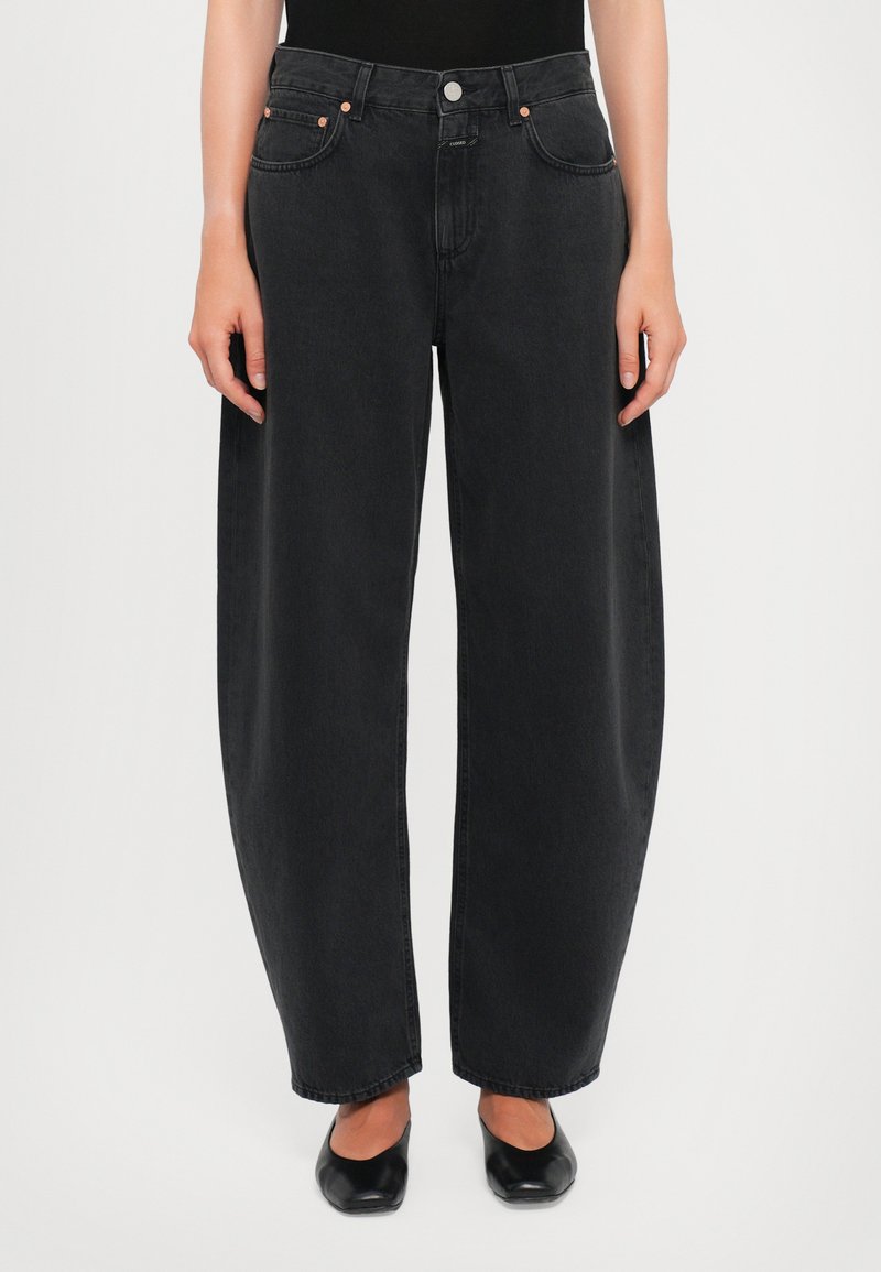 High-waisted, wide-leg black denim jeans with a smooth texture, five pockets, and copper hardware accents. Classic straight cut at the hem.
